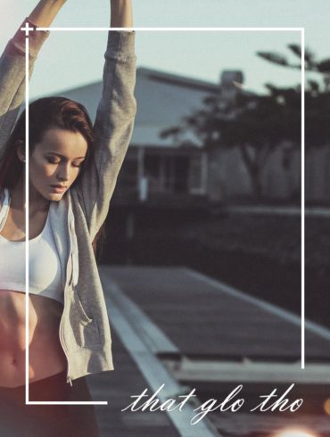 A woman is doing yoga on a dock.
