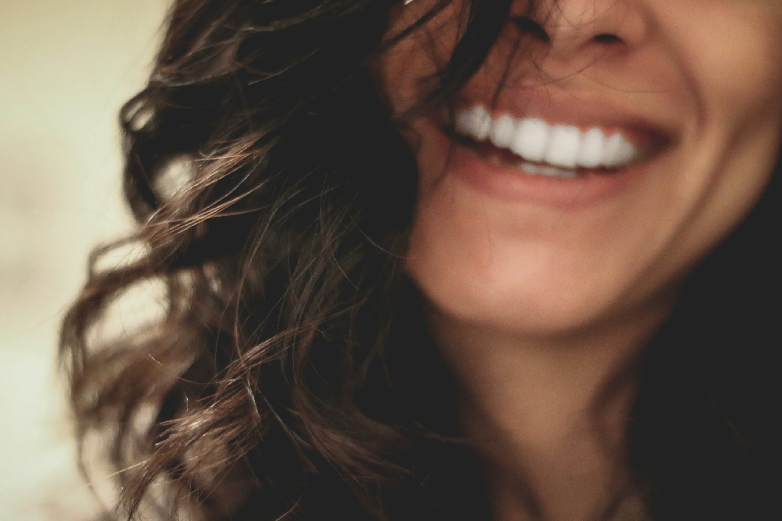 A close up of a woman smiling.