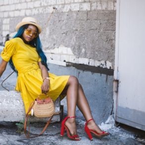 a woman in a yellow dress and red shoes