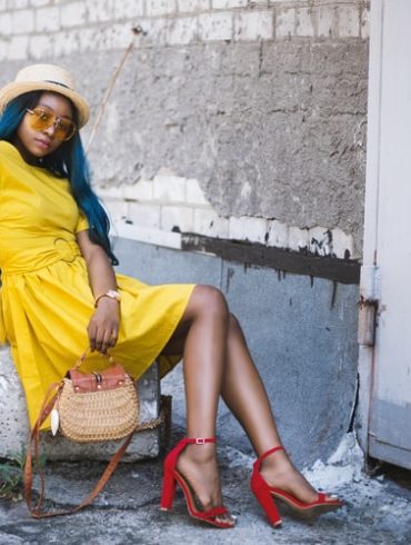 a woman in a yellow dress and red shoes