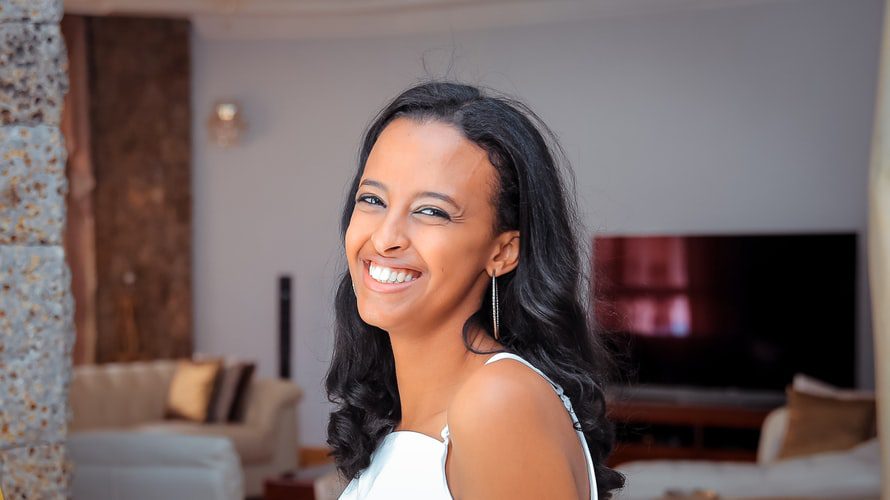 a young woman with long hair faces the camera