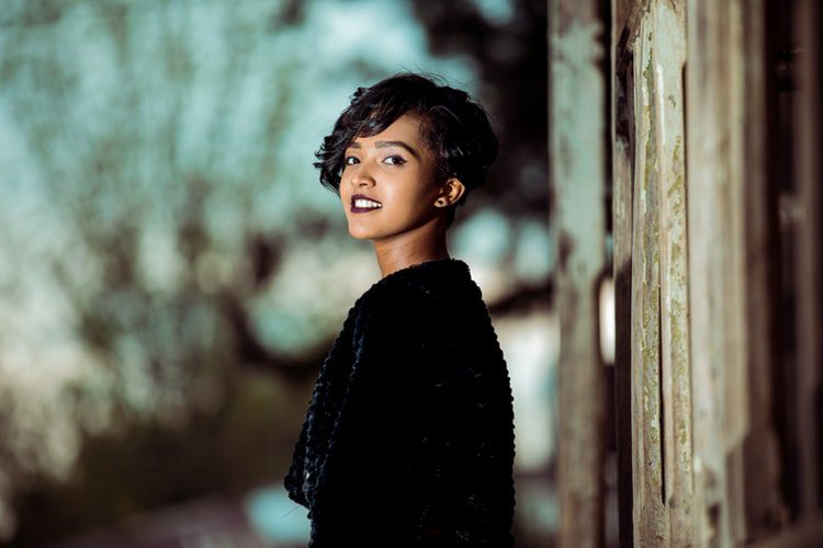 a woman with short, sassy hair smiles at the camera
