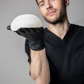 A plastic surgeon displaying a breast implant sample