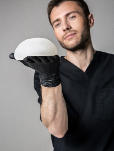 A plastic surgeon displaying a breast implant sample
